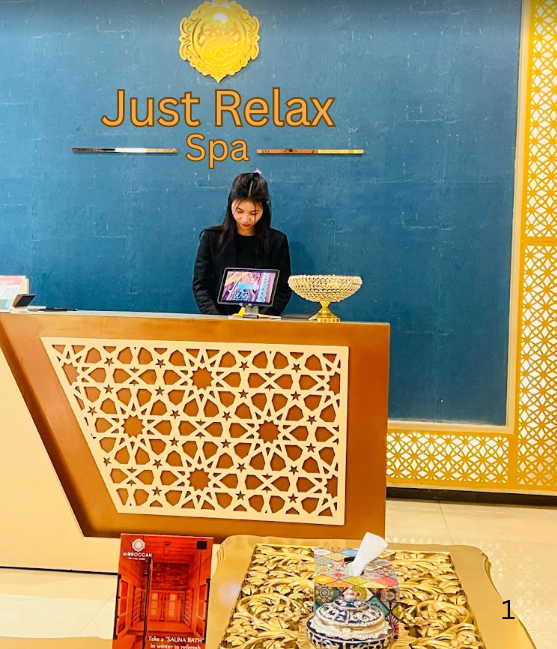 Reception desk with Just Relax Spa signage