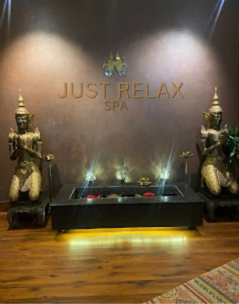 Just Relax Thai Spa signage with Buddha statues